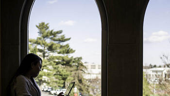 Student at Saint Joseph's University sitting and reading.