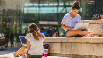 Students sitting outside Campion in the PLC