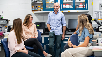 Professor with students in lab