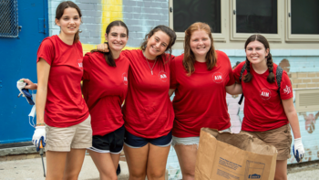 saint joseph's university students smiling at the camera