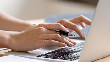 hands typing on laptop