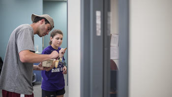 Students paint a wall for a service project