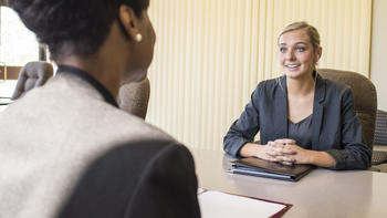 A student is interviewed by an employer