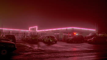 "Pink Line," a photo from Ydeen's series, shows a neon line glowing across an auto shop.