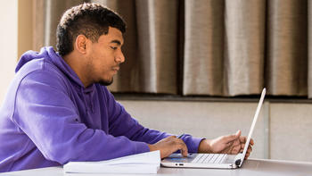 saint joseph's university student on a laptop