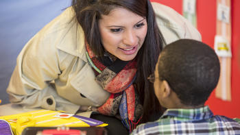a student helping teach a child