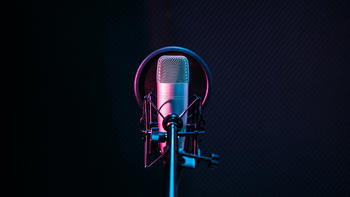 studio microphone and pop shield on mic in an empty recording studio
