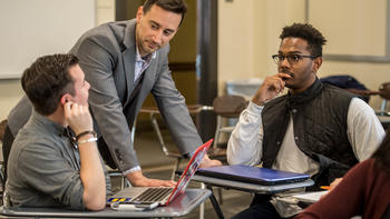 Students look to a teacher in a class