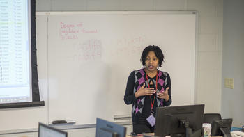 Professor teaching a class in one of our computer labs