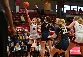Four players on the basketball court during the SJU-Drexel women's basketball team