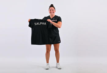 Carina Chieffalo ’25 holds a black 5ALPHA shirt in front of her