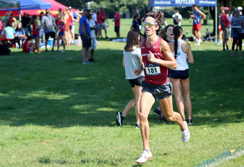 Saint Joseph's University cross country team running on field at Lehigh Invitational