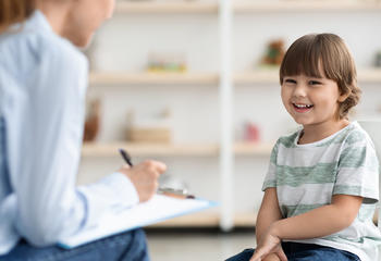 Counselor speaking to young patient in office