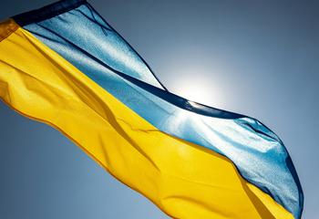 Ukrainian flag against a blue, sunny sky