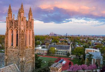 SJU campus at sunset with the Philadelphia skyline in the background.