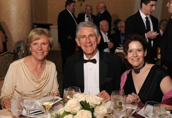 Three alumni seated for dinner at the University's Alumni Gala