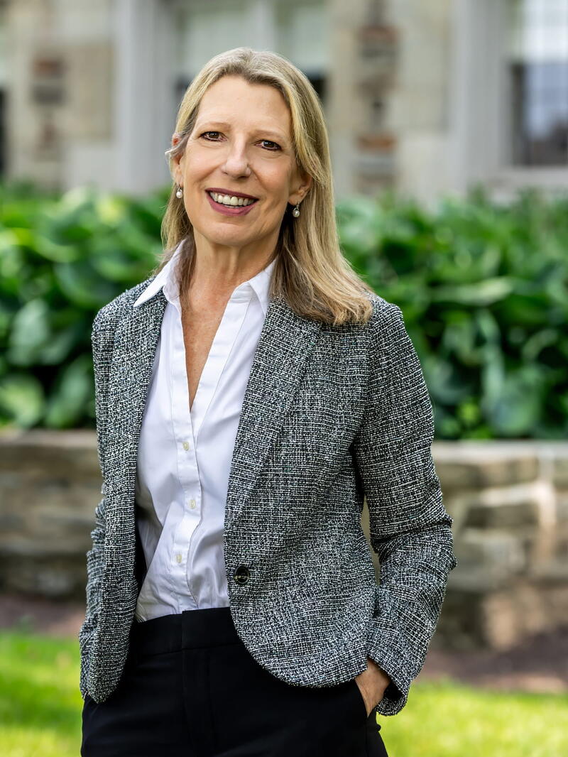 SJU President Cheryl Ann McConnell standing outside of Regis Hall