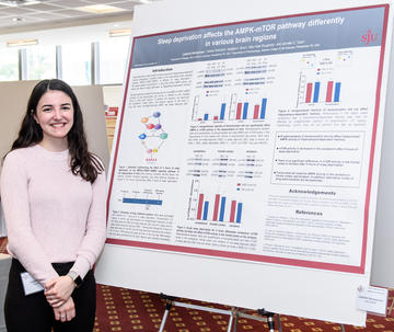 Student presenting research following Jesuit learning