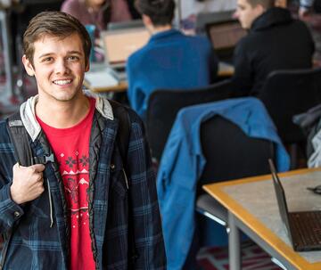 Saint Joseph's University admitted student in standing in library