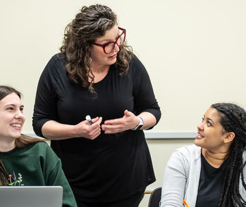 Saint Joseph's professor helping two female students in class