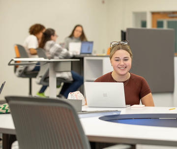 Saint Joseph's Lancaster student working on laptop in classroom