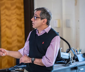 male professor with glasses leading a lecture