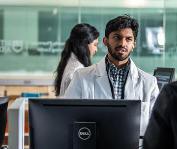 a saint joseph's university pharmacy student in a mock pharmacy