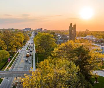 Aerial view of Saint Joseph's University campus at sunset looking down City Avenue with Barbelin tower in the background