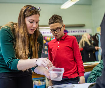 saint joseph's university student working with students at gompers elementary school