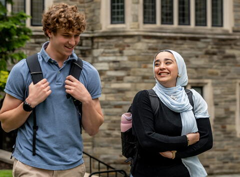 makle and female student walking and talking 