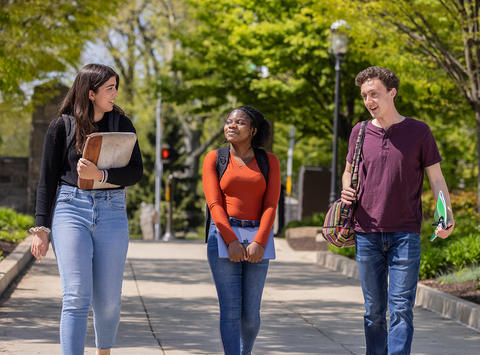 Undergraduate students walking towards Saint Joseph's Library