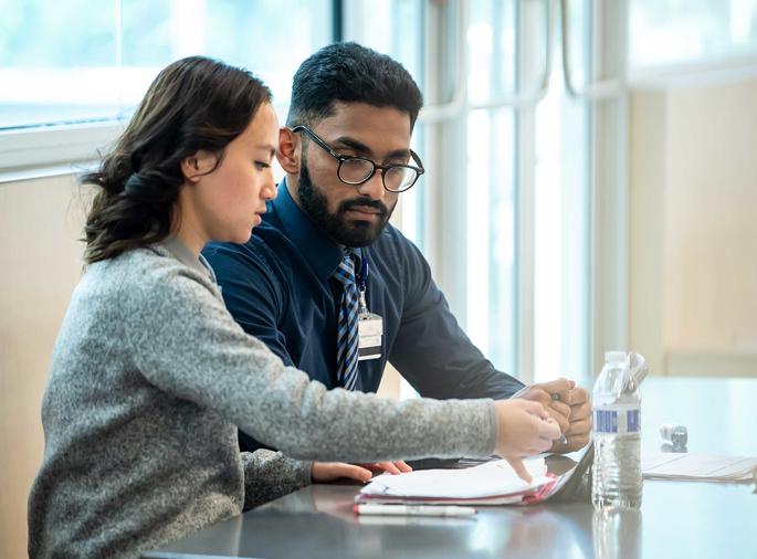 two graduate students doing school work at saint joseph's university
