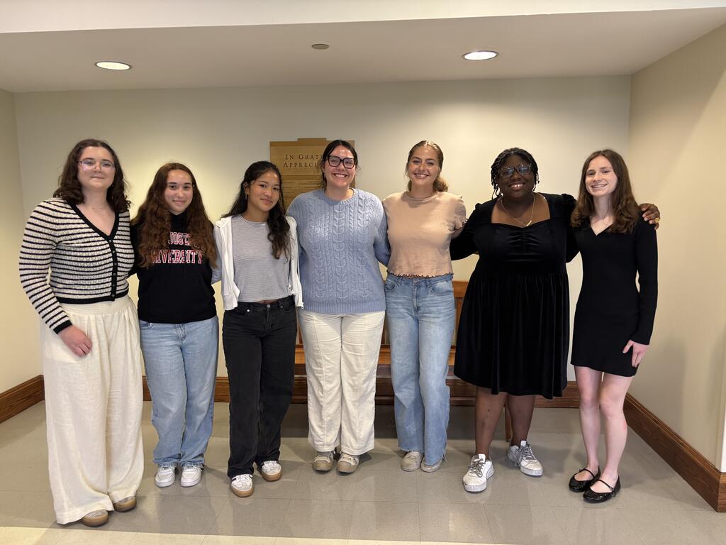 Seven students standing in a line