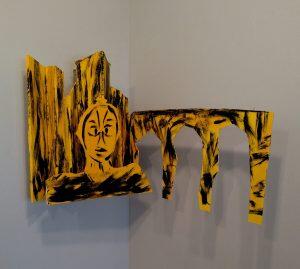 figure near bridge with skyline in background