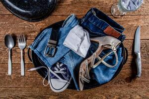 jeans, sneakers and women's shoes in a pot at a place setting