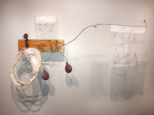 wire art work mounted to wall