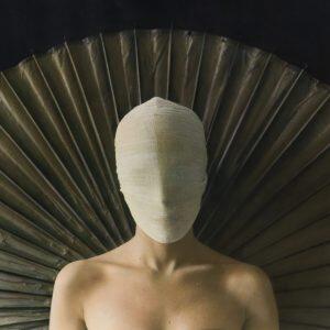 photograph of woman in gauze mask