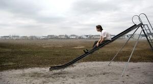 photograph of man going down slide