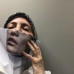 photo of man with ripped photograph over his face