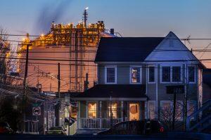 photo of house with refinery in the background