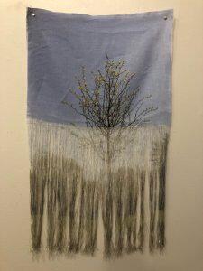 tattered fabric with image of tree superimposed