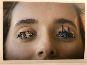 photograph of eyes with flowers growing out of them