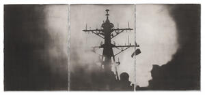 black and white photograph of battleship at night