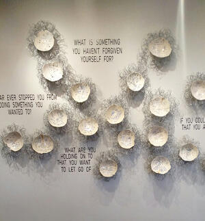 half moon of pottery and writing on wall