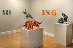 gallery space with sculptures on stands