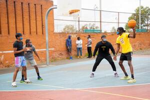 men playing basketball on a public court