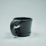 ceramic mug with small elephant tusk sticking out of the side