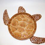 overhead photo of a turtle where the body of the turtle is a pie and the legs and head ceramic