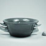 ceramic bowl with rhinoceros horns, including a broken one, sticking out of the side