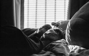 B+W photograph of someone in bed